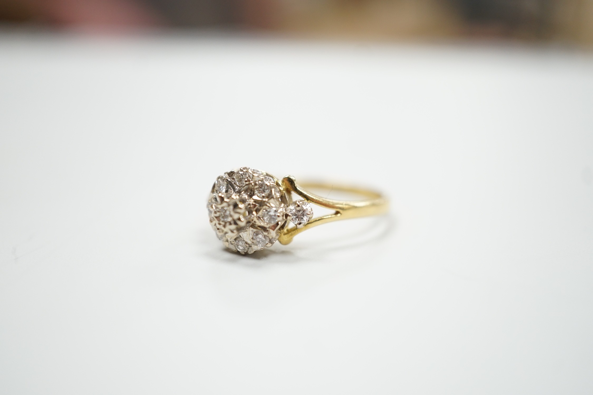 A modern 18ct gold and diamond chip set cluster ring, size 4 grams.